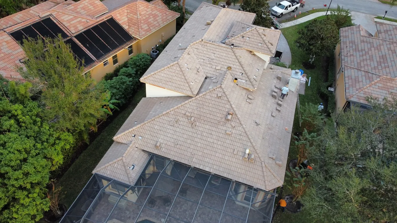 Aerial view of light tile roof being installed on a Treasure Coast home