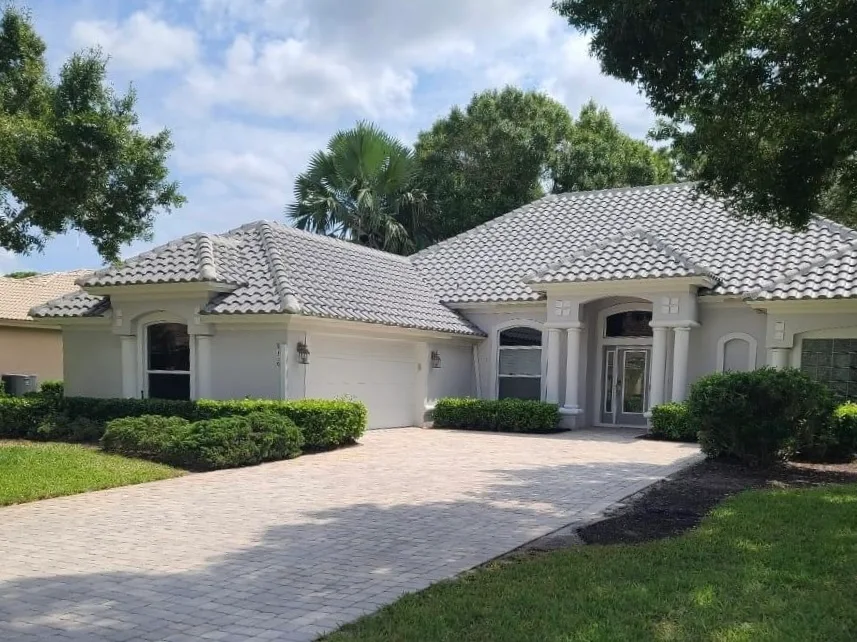 Completed gray tile roof on stucco Florida home