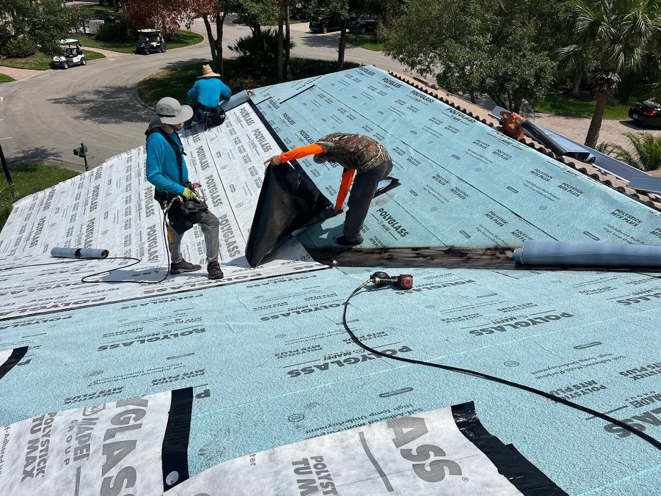 Rooftop Roofing crew installing Polyglass self-adhered underlayment